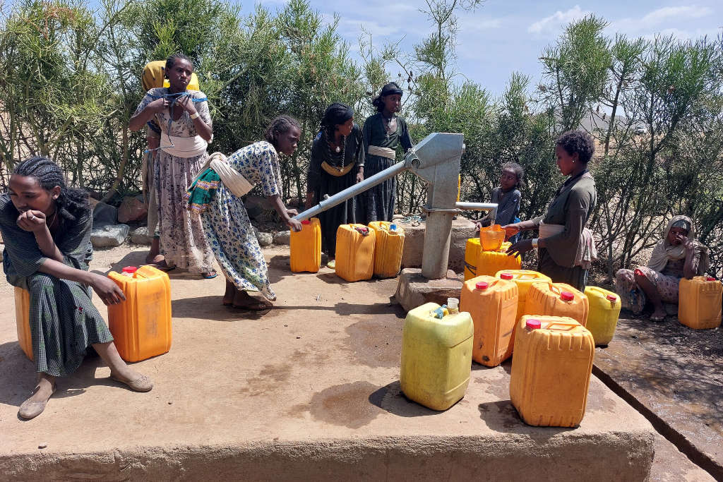 donne tirano l'acqua dal pozzo